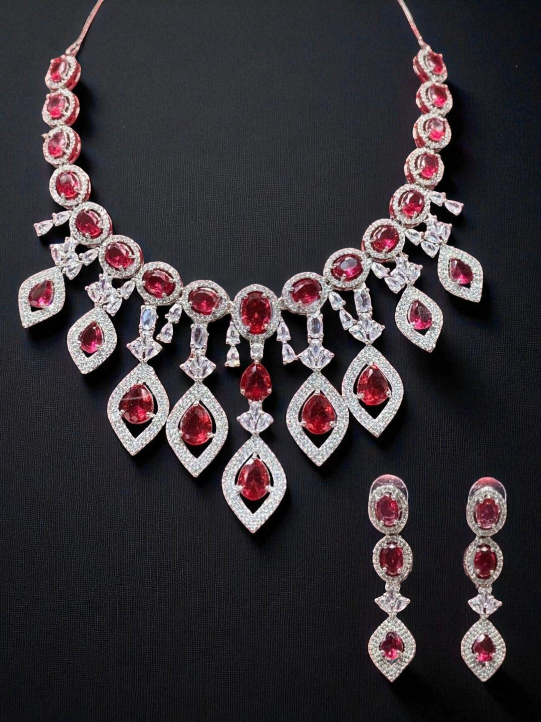 statement necklace, red stone jewellery, bridal set, luxury jewellery, modern ethnic, cocktail necklace, handcrafted jewellery, designer earrings, ruby look necklace, diamond finish jewellery