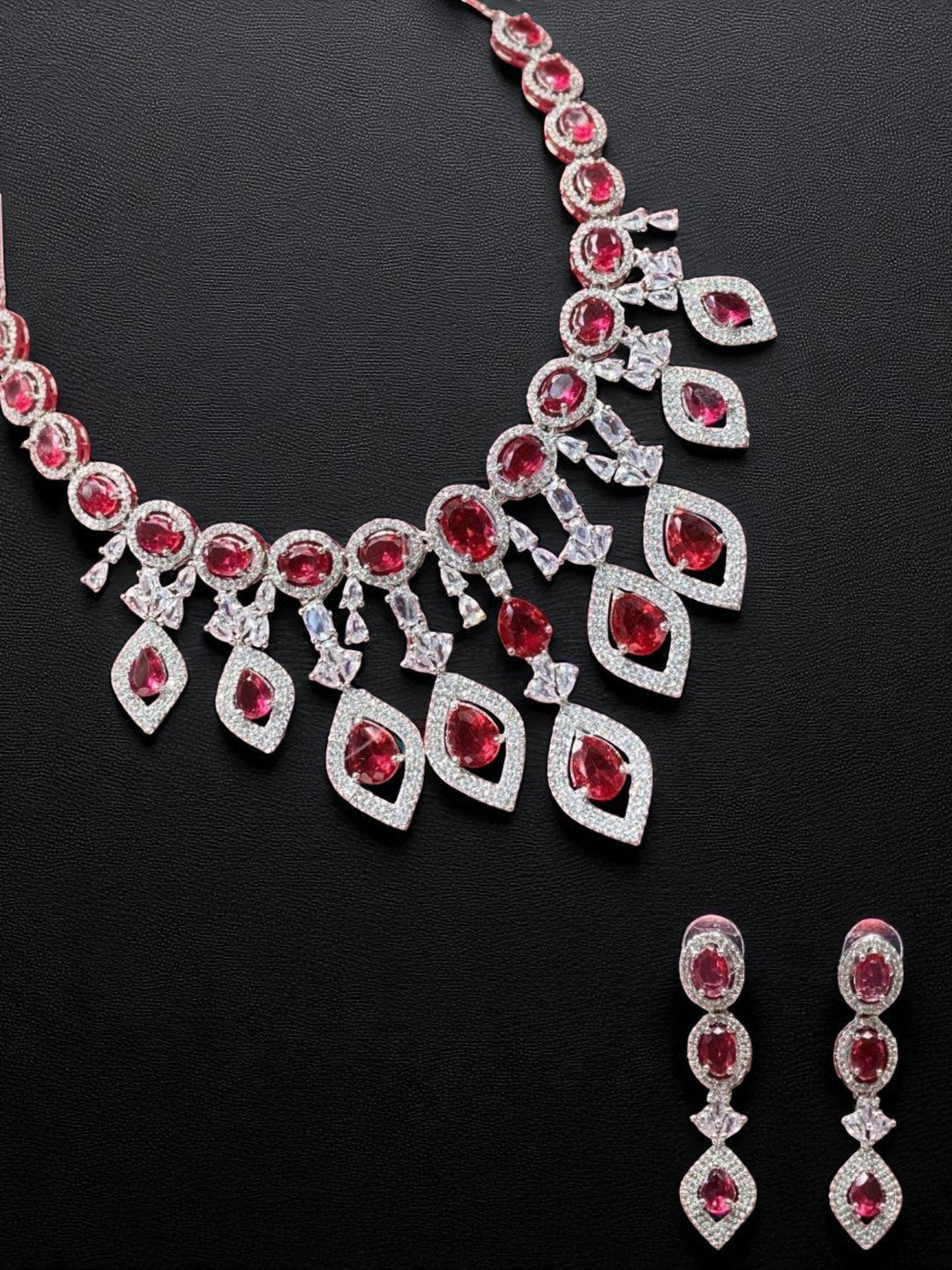 statement necklace, red stone jewellery, bridal set, luxury jewellery, modern ethnic, cocktail necklace, handcrafted jewellery, designer earrings, ruby look necklace, diamond finish jewellery