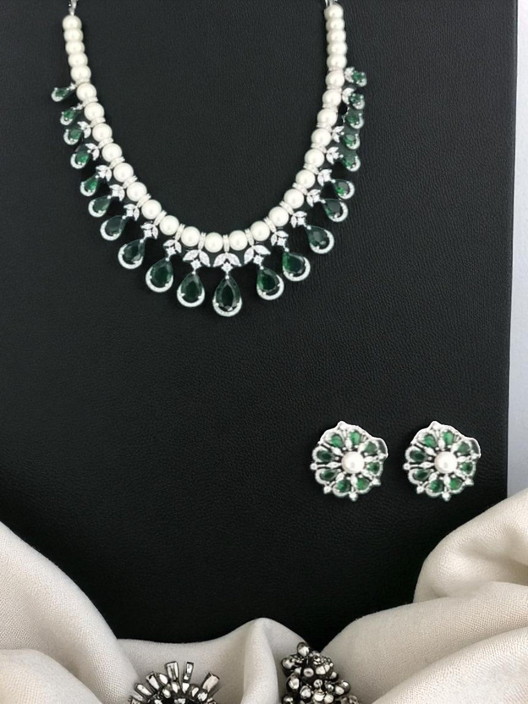 green and white jewellery, pearl necklace set, emerald drop jewellery, silver finish necklace, bridesmaid jewellery, lightweight festive jewellery, floral earrings set, pearl emerald jewellery, minimalist ethnic jewellery, modern indian jewellery