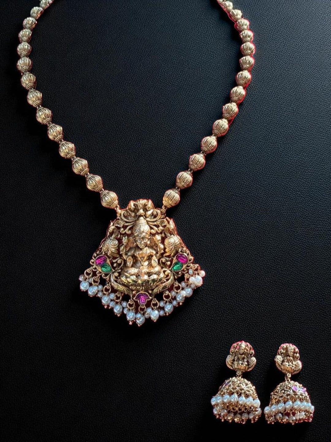 antique gold, devotion-inspired, traditional necklace, temple jewellery, goddess pendant, festive style, bridal collection, royal jewellery