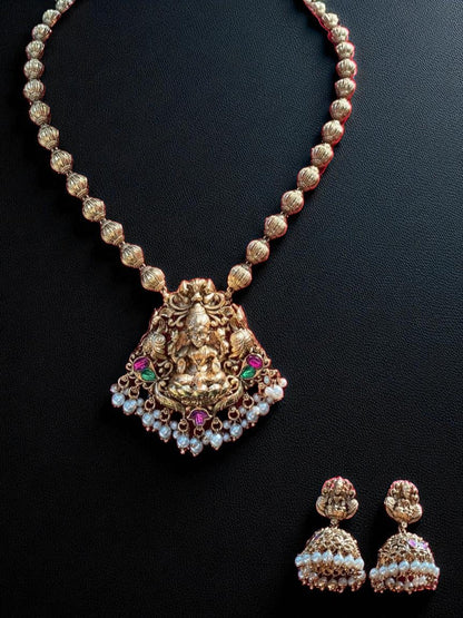 antique gold, devotion-inspired, traditional necklace, temple jewellery, goddess pendant, festive style, bridal collection, royal jewellery