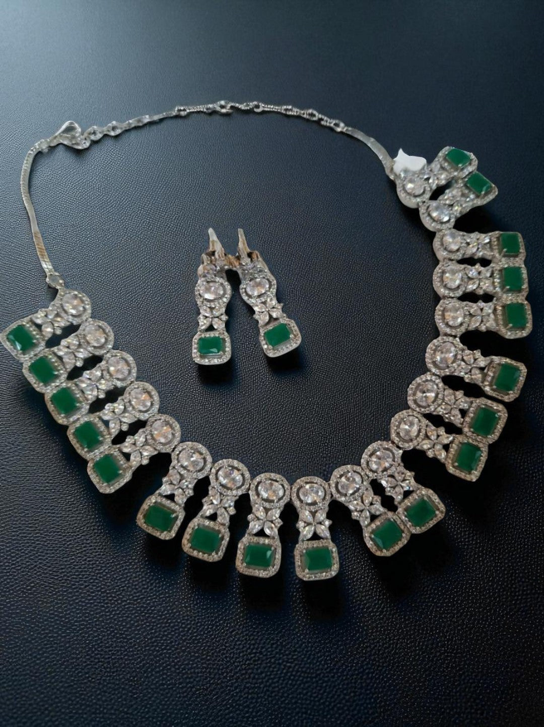 green stone jewellery, emerald necklace set, square cut necklace, traditional jewellery, bridal necklace set, American diamond jewellery, silver finish necklace, ethnic jewellery set, wedding jewellery, designer necklace and earrings