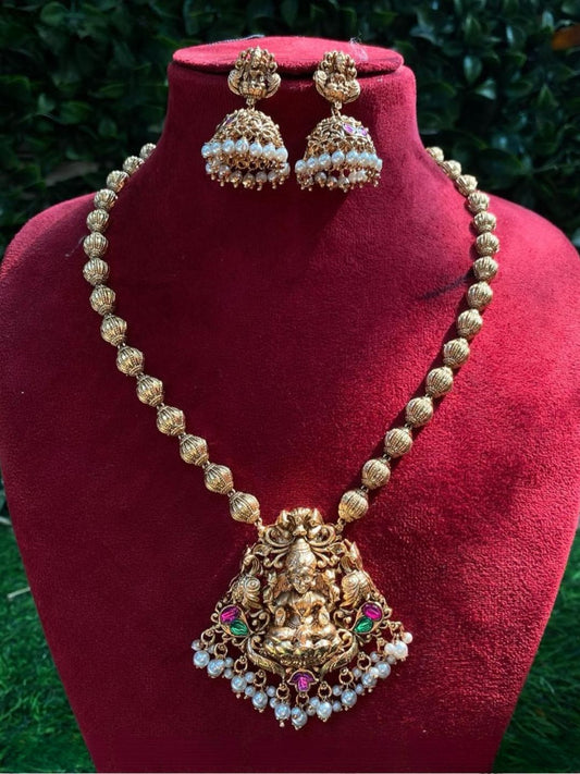 antique gold, devotion-inspired, traditional necklace, temple jewellery, goddess pendant, festive style, bridal collection, royal jewellery