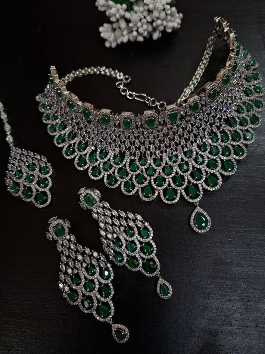 emerald bridal jewellery, diamond look choker, green stone necklace set, luxury bridal jewellery, statement wedding set, indian reception jewellery, emerald drop earrings, cocktail jewellery set, silver tone jewellery, designer bridal necklace, glam wedding jewellery, kundan inspired emerald set