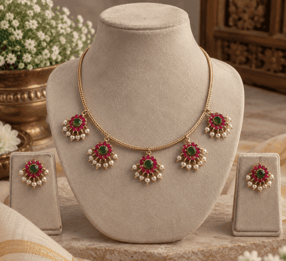 Gold look pink and green floral necklace displayed on jewellery mannequin