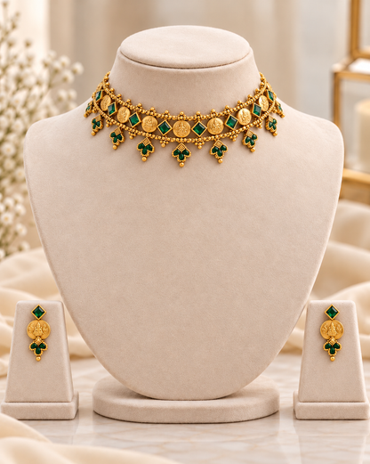 Antique gold look coin choker necklace displayed on mannequin with ruby-pink stone accents and matching traditional earrings