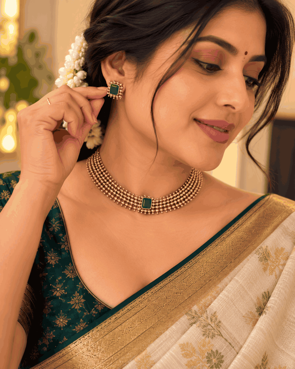 Model wearing antique gold look green stone beaded necklace set with matching green stone stud earrings