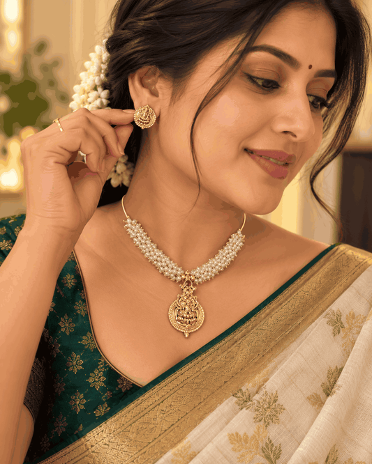 Model wearing Lakshmi temple-inspired gold look pearl necklace set with matching earrings