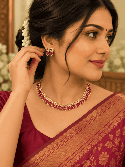 Model wearing gold look rani pink teardrop stone necklace with matching earrings by House of Praniv.